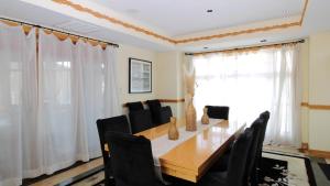 a dining room with a wooden table and black chairs at 1217 Beach -Villa Antinori in Cape May +21 photos