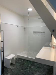 a bathroom with a glass shower with a bench at Riverside Retreat in Badefols-sur-Dordogne +58 photos