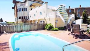 a swimming pool in front of a house at 1217 Beach -Villa Antinori in Cape May