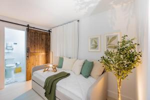 a bedroom with a white bed with a plant on it at Gorgeous Beach Front Condo Near Flagler Ave - 701 in New Smyrna Beach