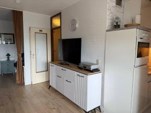 una cocina con encimera y TV. en Apartments, en Heiligenhafen