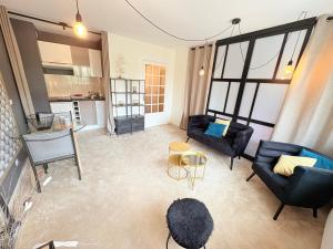 a living room with a couch and a table at Biarritz Centre Jardin Public et Gare du Midi in Biarritz +17 photos