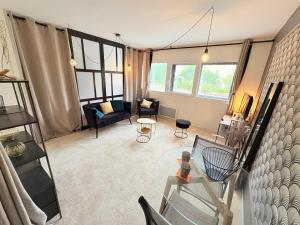 a living room with a couch and a glass table at Biarritz Centre Jardin Public et Gare du Midi in Biarritz