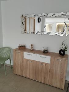 - un miroir au-dessus d'une commode en bois dans l'établissement Maison de vacances à la plage, à Créances