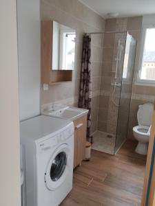 une salle de bains avec lave-linge et lavabo dans l'établissement Maison de vacances à la plage, à Créances 8 autres photos