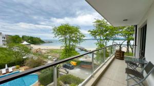 a balcony with a view of a beach and the ocean at Green Paradise Deluxe Apartments in Primorsko