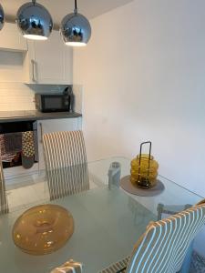 a kitchen with a glass table and two chairs at Shorething in Saint Martin +7 photos