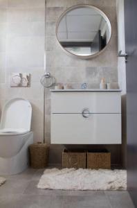 a bathroom with a white toilet and a mirror at Nova Beach Penthouse in Gran Alacant