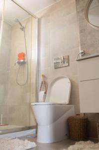 a bathroom with a white toilet and a shower at Nova Beach Penthouse in Gran Alacant +15 photos