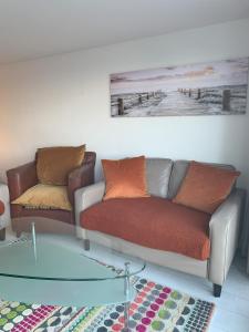a living room with a couch and a glass table at Shorething in Saint Martin