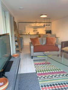 a living room with a couch and a glass table at Shorething in Saint Martin
