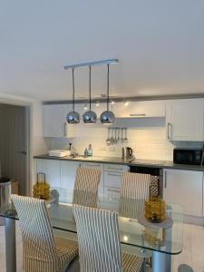a kitchen with a glass table and two chairs at Shorething in Saint Martin