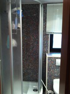 a bathroom with a shower with a toilet and a sink at Ulrikesferienwohnung2 in Homburg