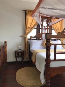 Кровать или кровати в номере Usangi House