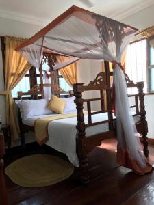 Кровать или кровати в номере Usangi House