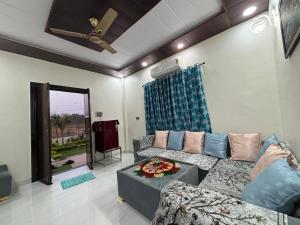 a living room with a couch and a table at Bhim Ranjana Villa in Padmāpur