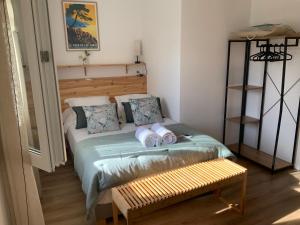 a small bedroom with a bed and a bench at U FARNIENTE in Patrimonio