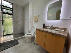 ein Badezimmer mit Toilette, Waschbecken und Dusche in der Unterkunft Dormitorio con baño privado es Tu descanso en el corazón de San Salvador in San Salvador + 31 Fotos