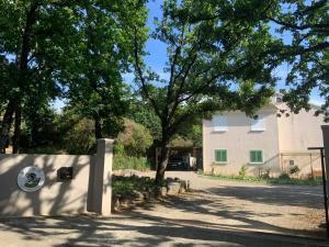 a building with a fence and trees in front of it at U FARNIENTE in Patrimonio