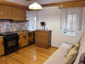 a kitchen with a stove and a couch in a room at VintageVibes in Skala Marion +16 photos