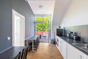 a kitchen with white cabinets and a counter top at Top-Lage - Top-Wohnung in Leipzig