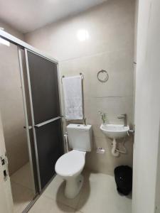 a bathroom with a toilet and a sink at Loft 672 in Petrolina +20 photos