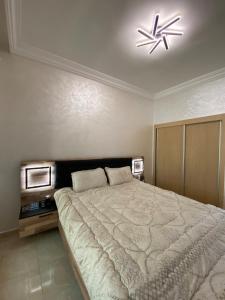 a bedroom with a large bed and a ceiling fan at Luxury sea view apt tanger with Swimming pool in Tangier +42 photos