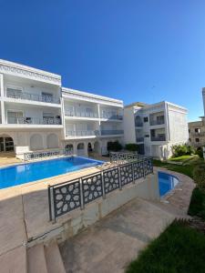 a large apartment building with a swimming pool at Luxury sea view apt tanger with Swimming pool in Tangier