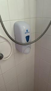 a toilet paper dispenser on a wall in a bathroom at Chez Lilly in Oranjestad