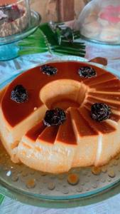 a cake with fruit on top of it on a plate at Chez Max Pousada in Morro de São Paulo