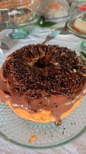 a chocolate covered donut sitting on a glass plate at Chez Max Pousada in Morro de São Paulo