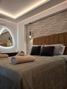 a bedroom with a large bed and a large mirror at Prifti Luxury apartment in Faliraki