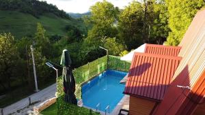 a swimming pool on the side of a house at AM Pyramid resting in Visoko