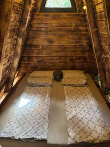 a large bed in a room with a window at AM Pyramid resting in Visoko