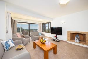 a living room with a couch and a fireplace at Villa Elena in Kalathos