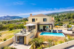 a villa with a swimming pool and a house at Villa Elena in Kalathos