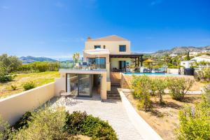 a villa with a view of a house at Villa Elena in Kalathos