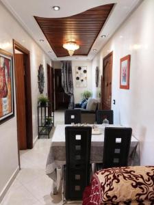 a dining room with a table and a couch at Appartement avec terrasse au cœur du centre-ville de Rabat in Rabat