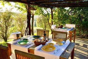 a table with plates of food sitting on a patio at L'Olmo in Monticchiello