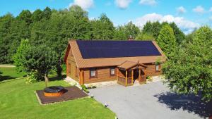 an overhead view of a log cabin with a solar roof at House in Krikstonys in Krikštonys