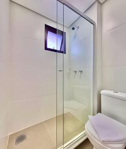 a glass shower in a bathroom with a toilet at Aprazivel Studio no centro de curitiba in Curitiba