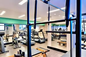 a gym with treadmills and elliptical machines at Aprazivel Studio no centro de curitiba in Curitiba