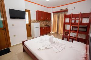 a bedroom with a bed with a white bird on it at Vila Anna in Ksamil