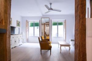 - un salon avec des chaises et un ventilateur de plafond dans l'établissement Apartment Fomento, à Madrid