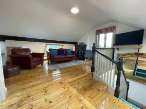 a living room with a staircase and a couch at Worcester City Centre self check-in cosy loft apartment in Henwick