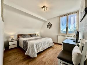 a bedroom with a bed and a window at La Roseraie in Vitrac +43 photos