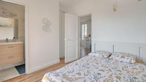 una camera da letto bianca con un letto e un bagno di Vitry Vibes City a Vitry-sur-Seine