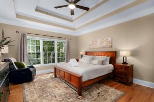 a bedroom with a bed and a ceiling fan at Big Sky - Pet Friendly Big Canoe GA Cabin-Modern amenities, hot tub, pet friendly, mountain views, access to lakes, golf courses in Afton