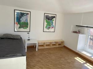 a bedroom with a bed and a table in it at Centro Stazione Attico in Turin +20 photos