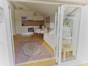 a living room with a table and a kitchen at Centro Stazione Attico in Turin